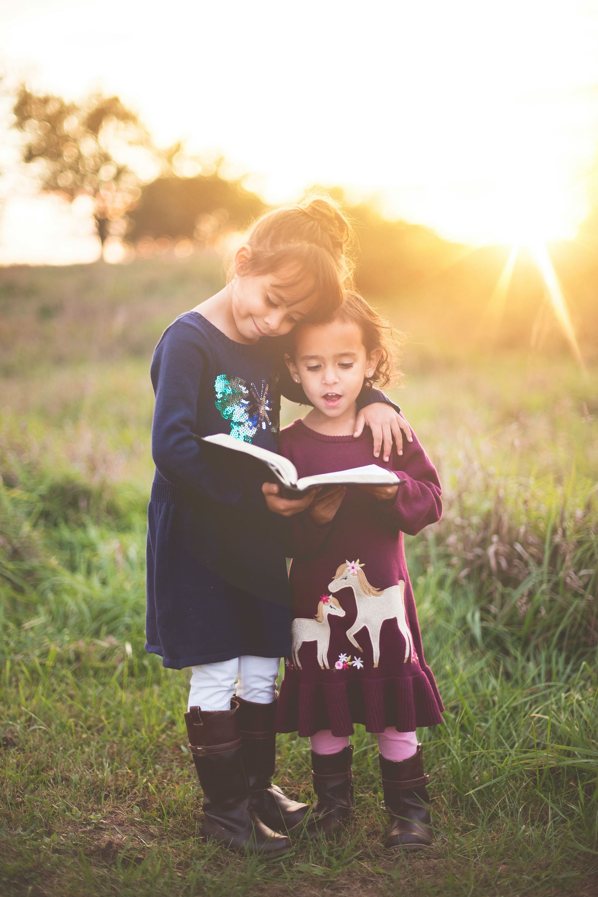a pair of children reading a book