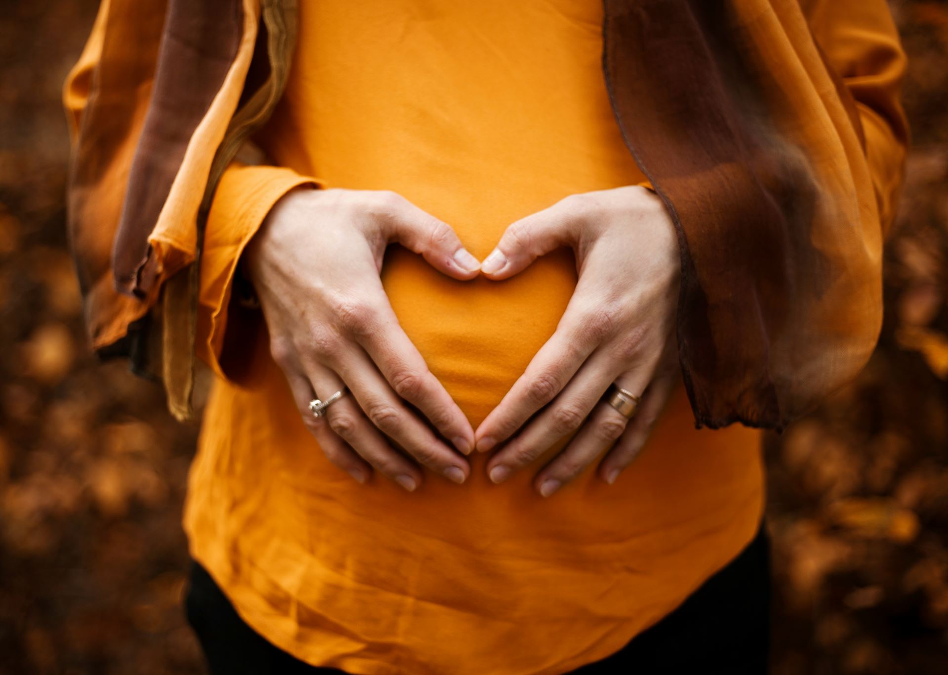 a pregnant woman with her hands on her belly