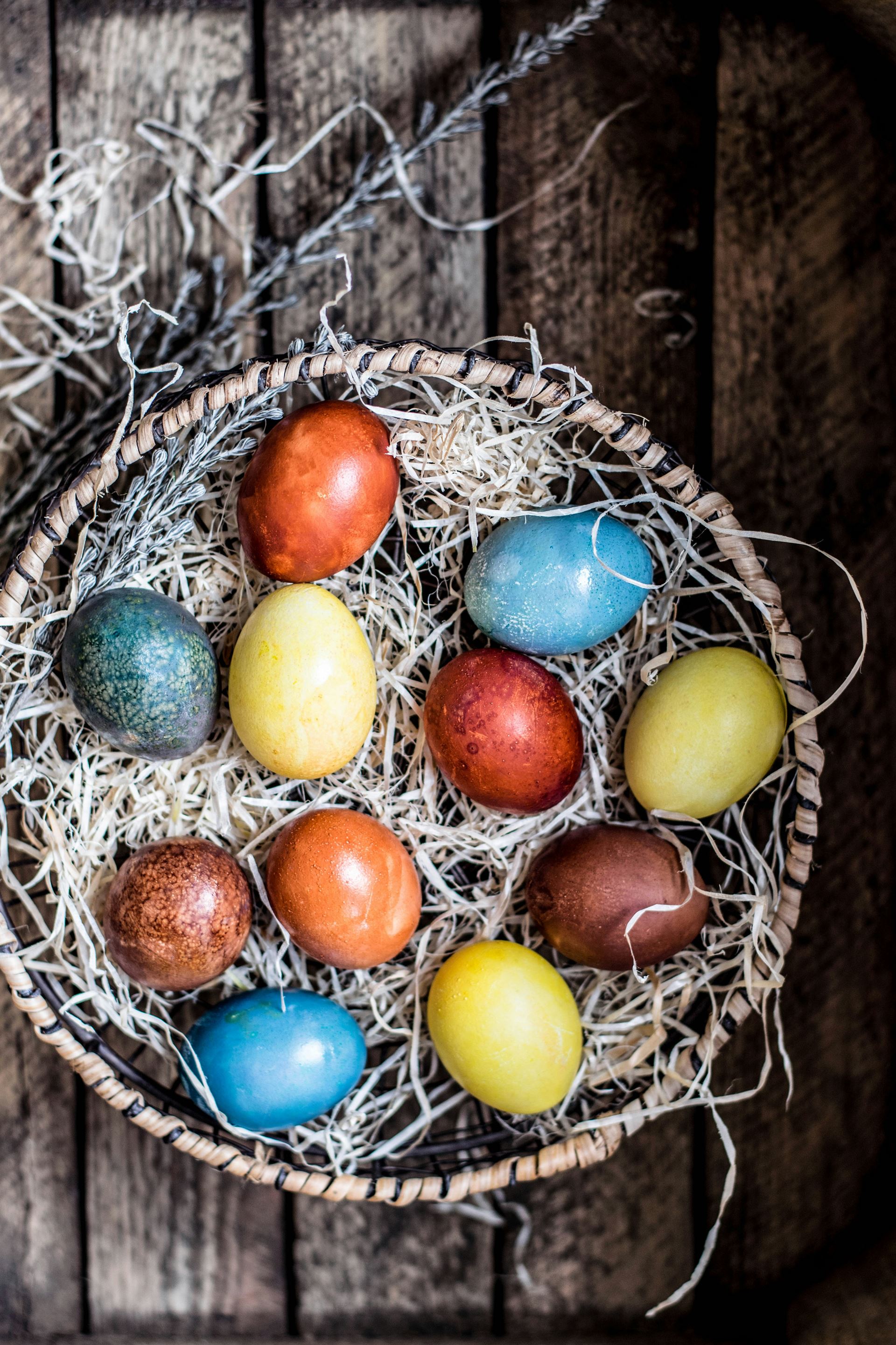 coloured easter eggs in a wicker basket