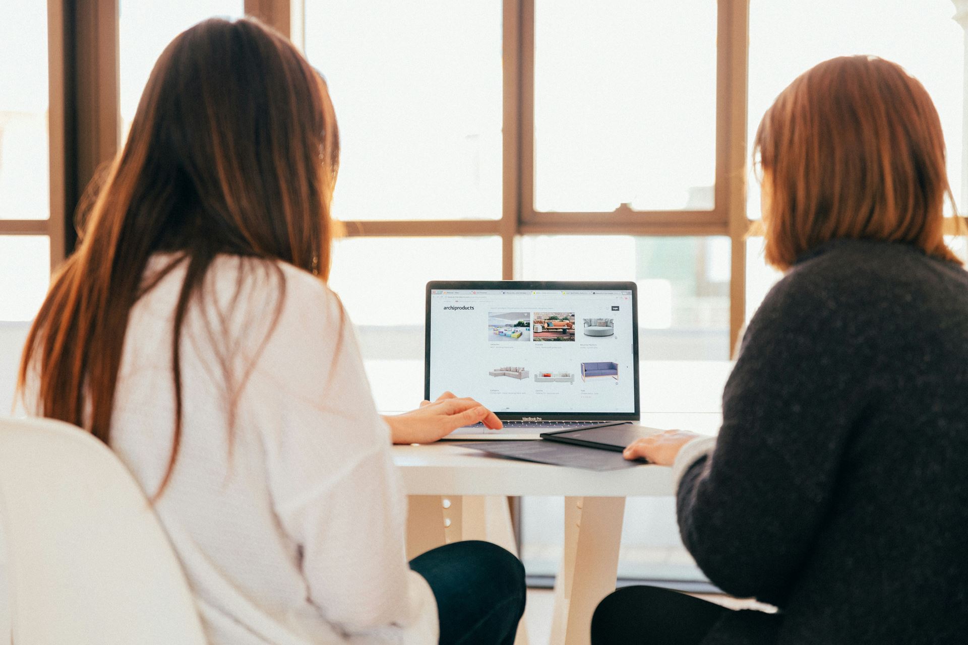 two people looking at a computer display