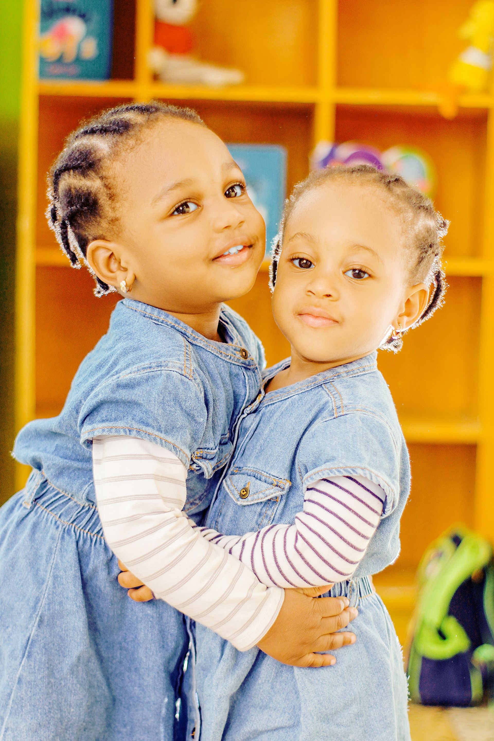 two toddler girls hugging eachother