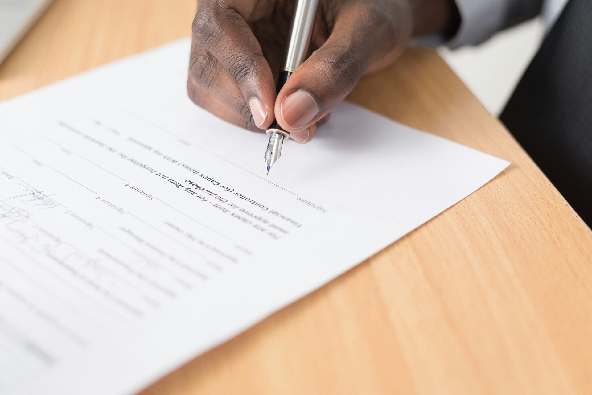 a person signing a form