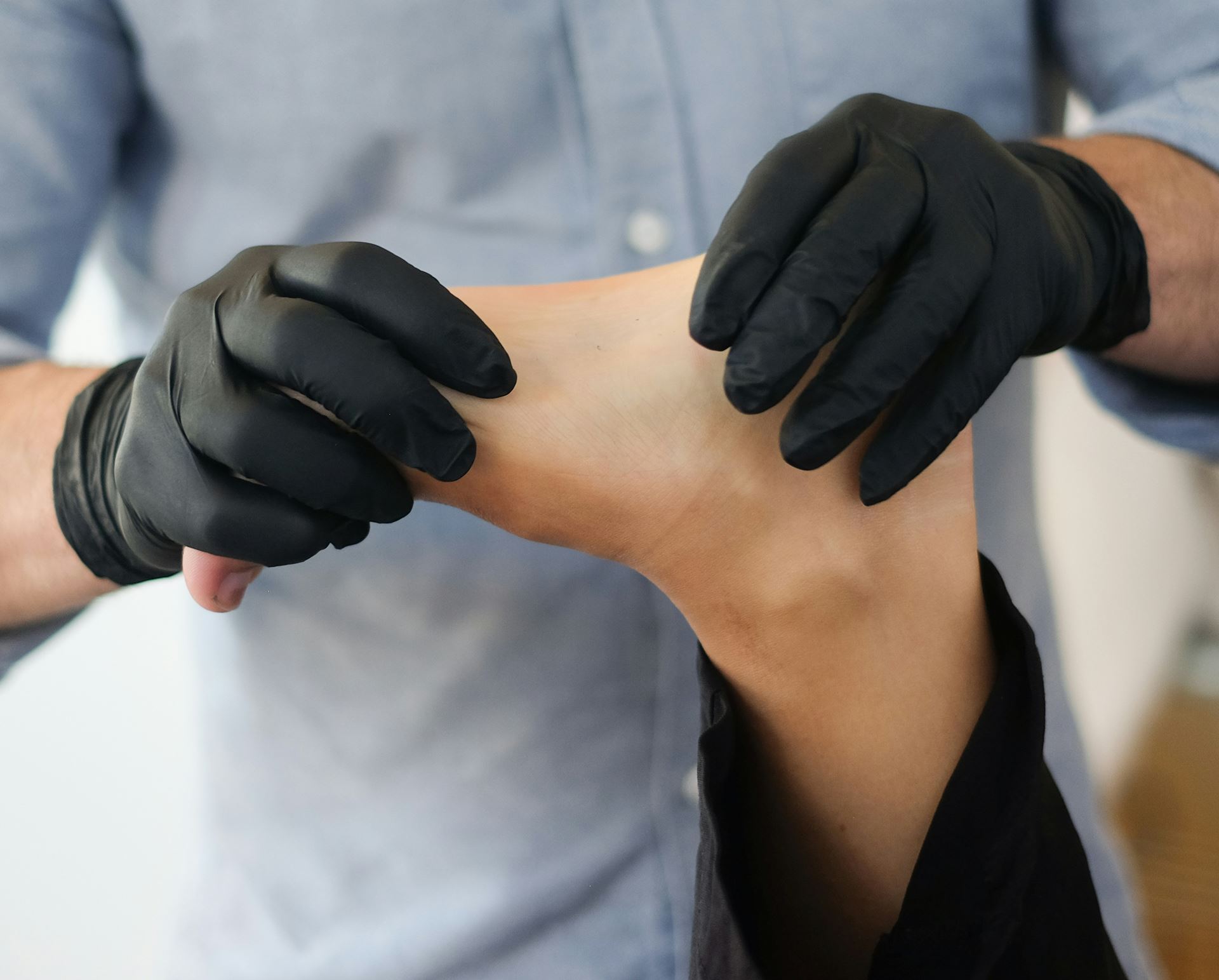 a physiotherapist working on a person's foot