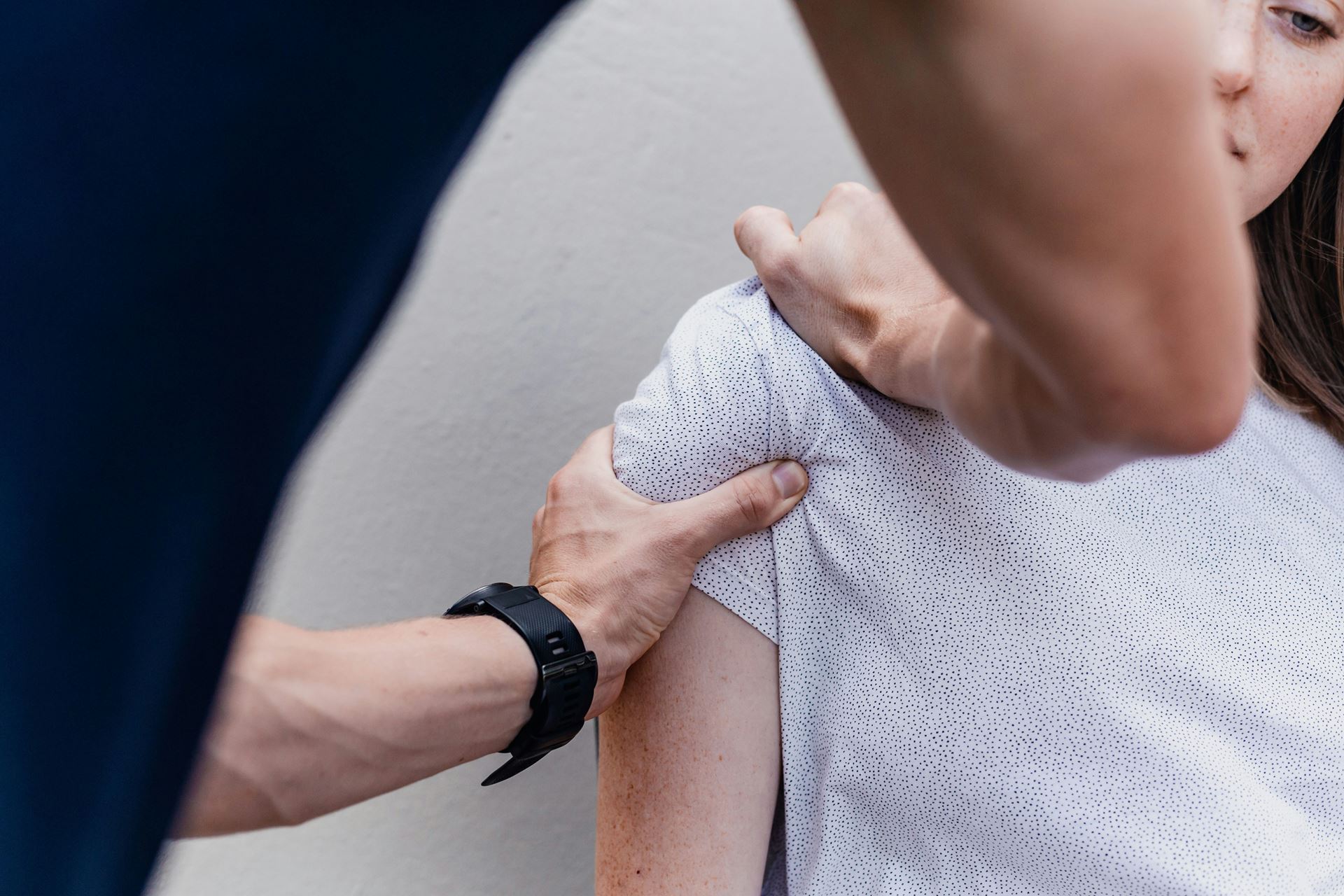 a physiotherapist working an a patient
